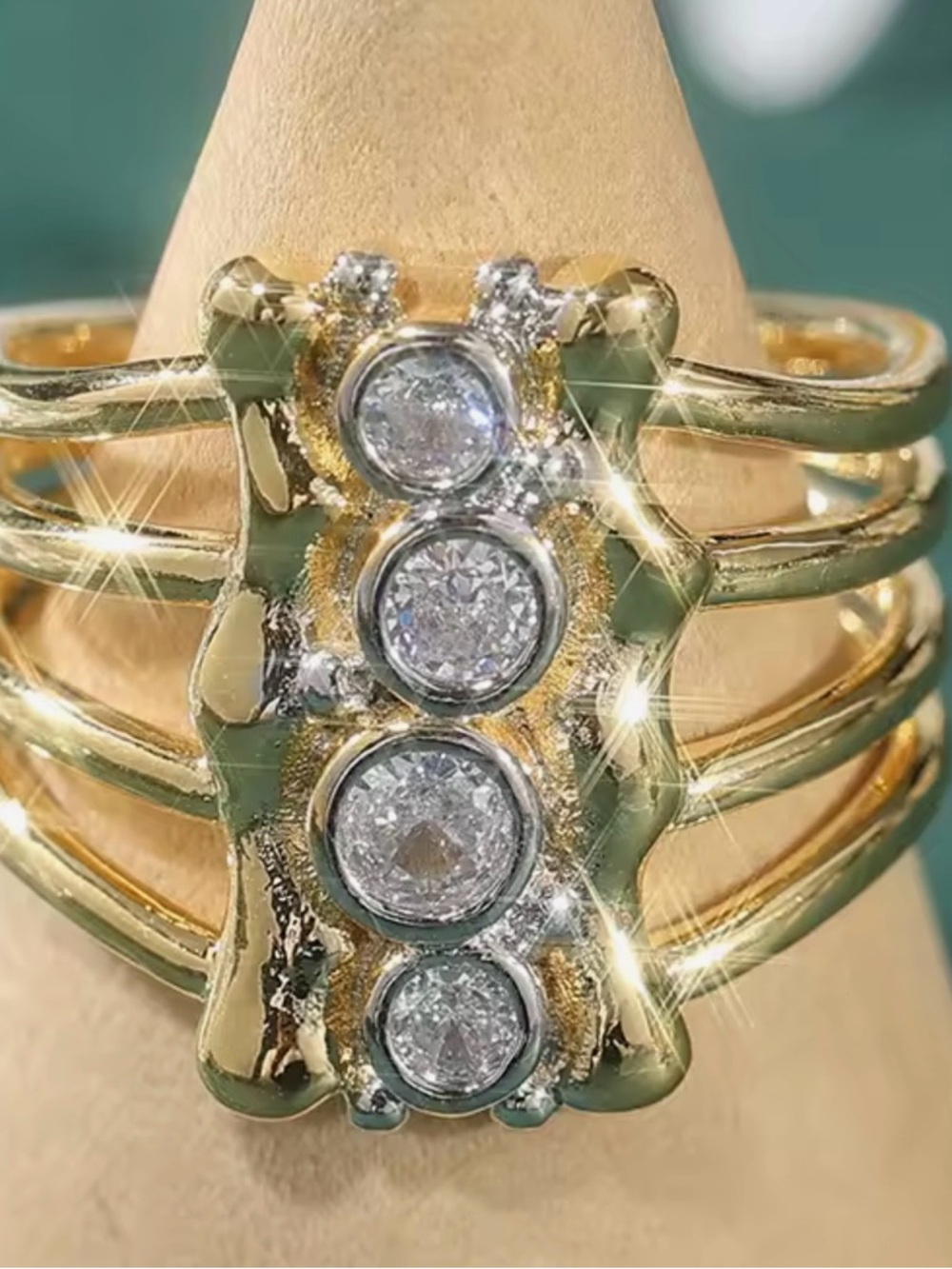 Elegant Gold Ring with Four Bezel-Set White Stones